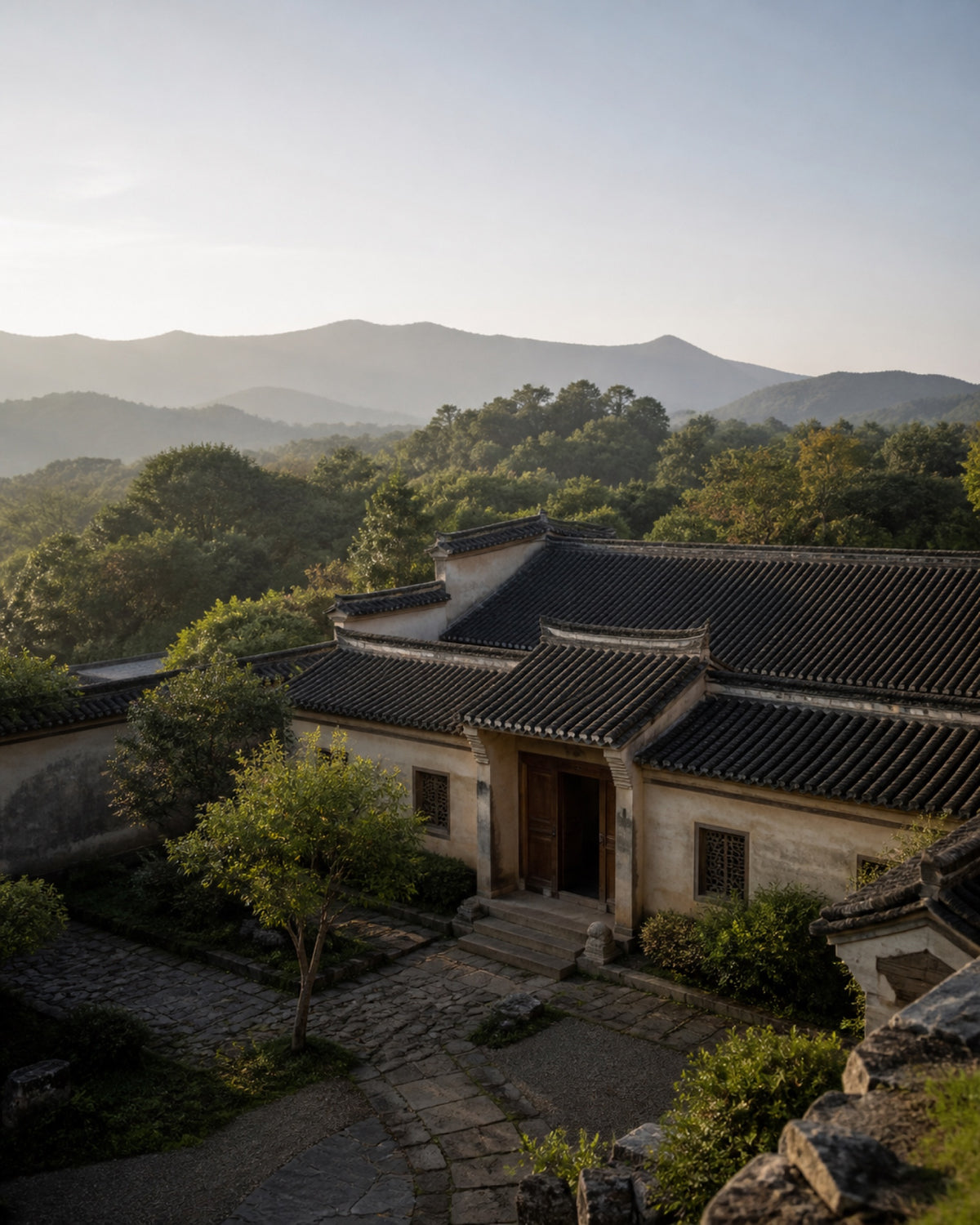 Traditional Chinese courtyard set within a mountain landscape